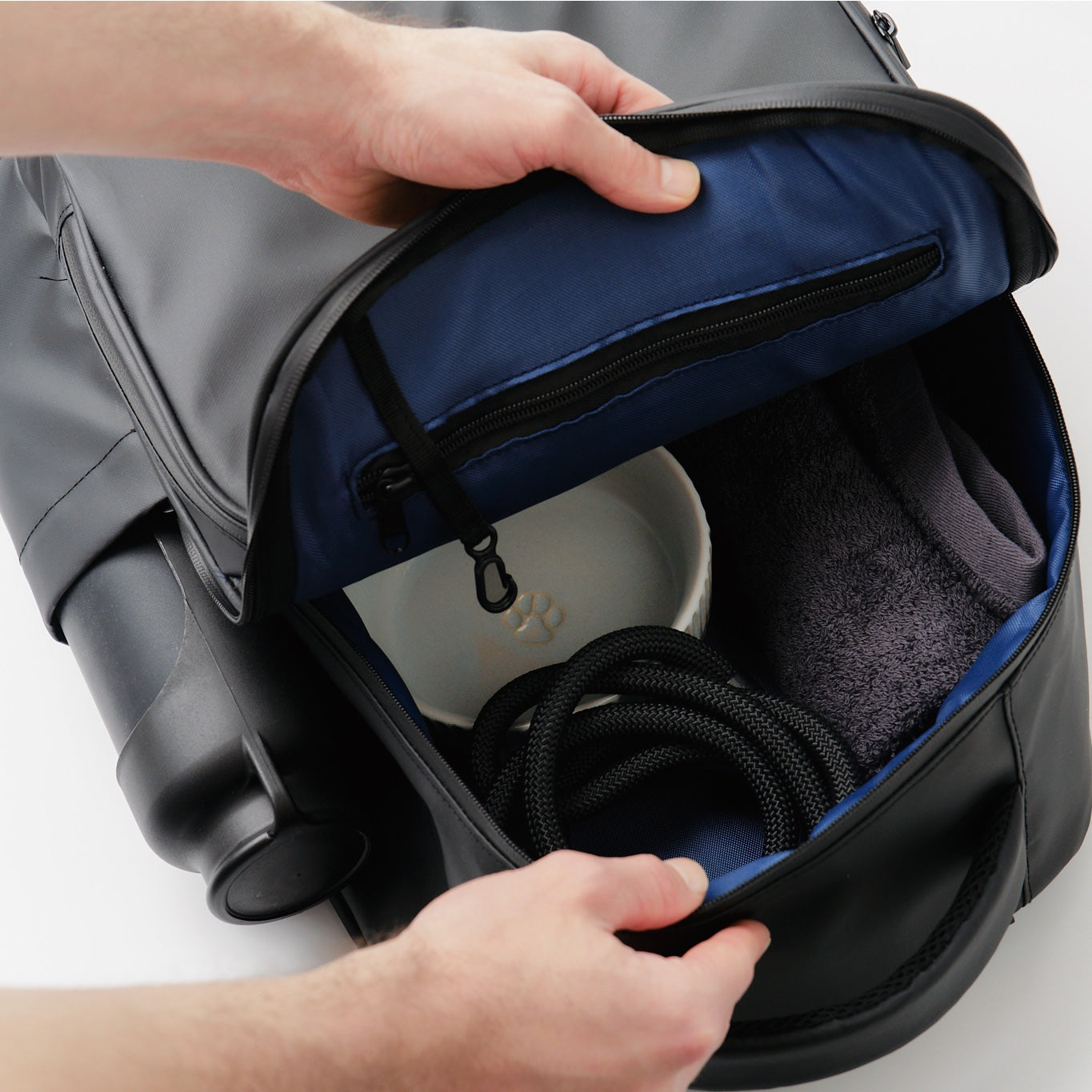 Open black Fetchamo Core Backpack displaying the main compartment, internal storage pockets and dog walking essentials.