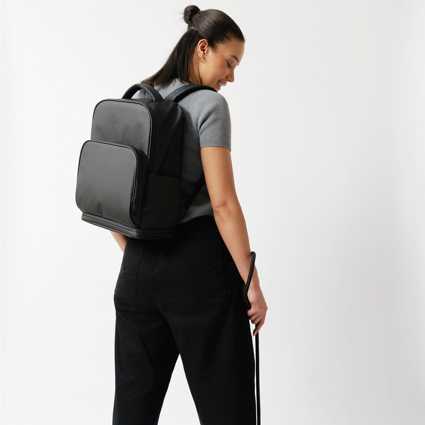 fetchamo Core backpack for dog owners – rear view of model wearing the backpack with dog beside her on a lead